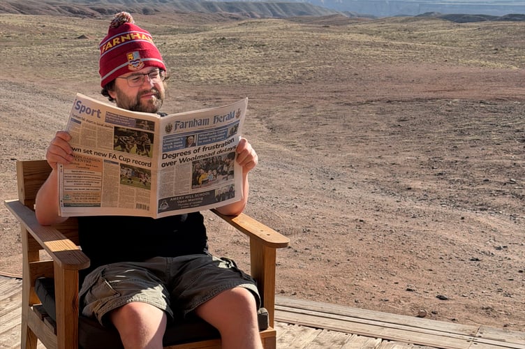 Richard Major has just returned from a few weeks driving around Kazakhstan. He’s pictured reading the paper — and wearing his Farnham Town FC woolly hat — on the decking of a tent he stayed in for a night in the desert. A mere 3,600 miles from home… can any other readers beat that?