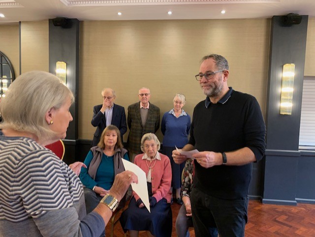 Madeleine Boxall presents a £1,000 cheque to Howard Bicknell, Manager of Haslemere Hall, with members of The Arts Society Haslemere committee.