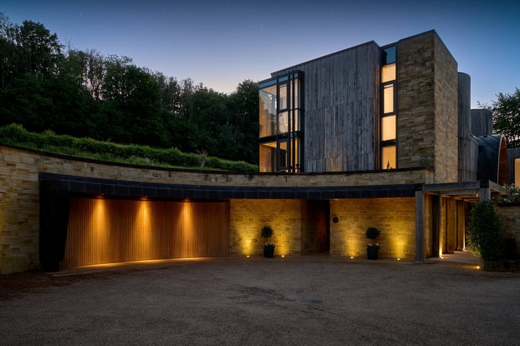 Downley House in South Downs National Park, near Petersfield, Hampshire. A house that was featured on Grand Designs has had to slash its price by a whopping £750,000 after failing to sell for 18 months.Downley House was listed for sale in July 2024 with a guide price of £5 million when owner Chris Taee decided it was time to sell up after 12 years in the property.Taee built the 7,374 sq ft oak-clad house from scratch, which boasts five bedrooms - three in the family wing and two guest bedrooms - five bathrooms and an oval-shaped central dining area with a 23ft high ceiling.The house was used by Kevin McCloud to host the Grand Designs House of the Year show there, whilst also being shortlisted for the RIBA House of the Year award.The property is built on 2.5 acres within a valley of South Downs National Park, near Petersfield, Hampshire.