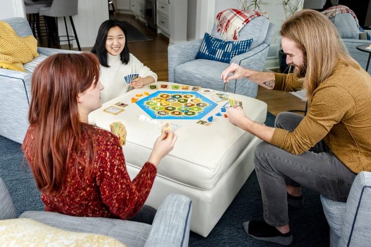 Friends enjoying Catan Asmodee Bordon