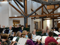 Audience gives great thanks for music of band and choir