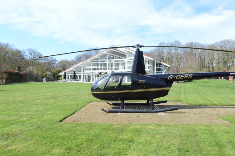 This luxury mansion with an entirely glass exterior is on sale for £4 million- with its own tennis courts and helicopter pad. A five-bedroom house within 20 acres of its own woodland on the Surrey and Sussex border has hit the market which has a striking glass exterior. The gardens of the property in Billingshurst, West Sussex, feature a three-acre lake with rainbow trout, a fishing pontoon, a workshop, a dehumidified multi?car garage, and a cottage. There is also an unrestricted helipad, and an air conditioned storage hanger to keep your helicopter in- which doubles as a golf simulator.