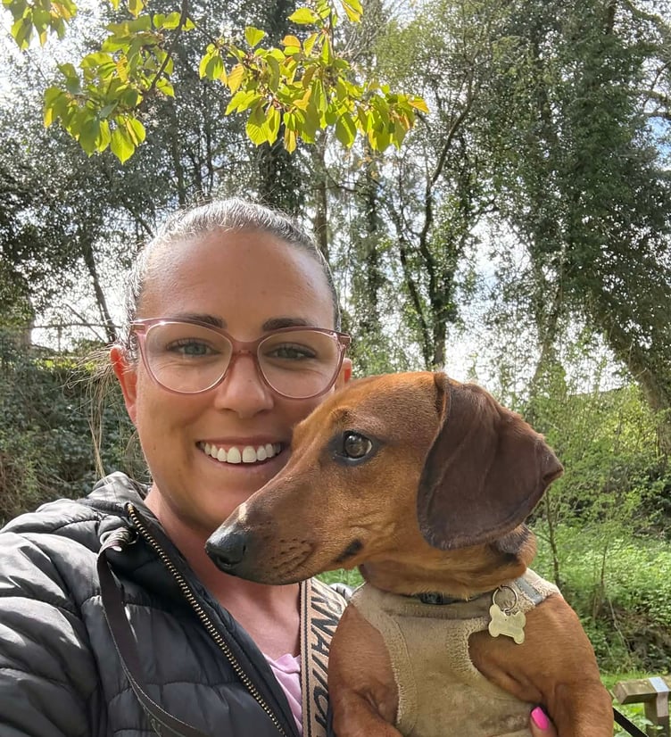 Holly Soal with her dachshund Dobby as she takes on her fundraising challenge after surviving childhood cancer.