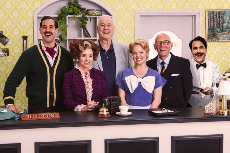 Fawlty Towers, Woking Theatre, May 26th to 30th 2026. From left: Danny Bayne, Mia Austen, John Cleese, Joanne Clifton, Paul Nicholas and Hemi Yeroham.