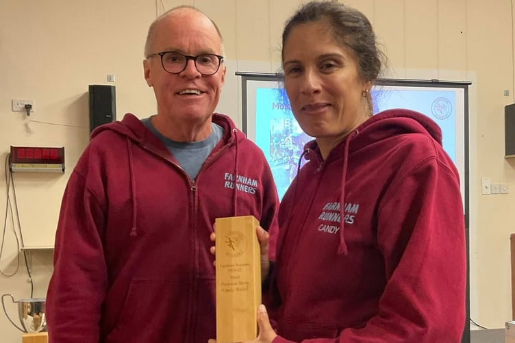 Candy Waller is presented with the ladies' trophy for the most personal bests